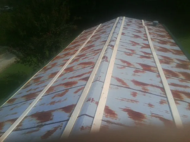 Rusted metal roof panels with new wood purlins before replacement — Storm Damage Roof Repair in Coeymans Hollow by Roofing Brothers