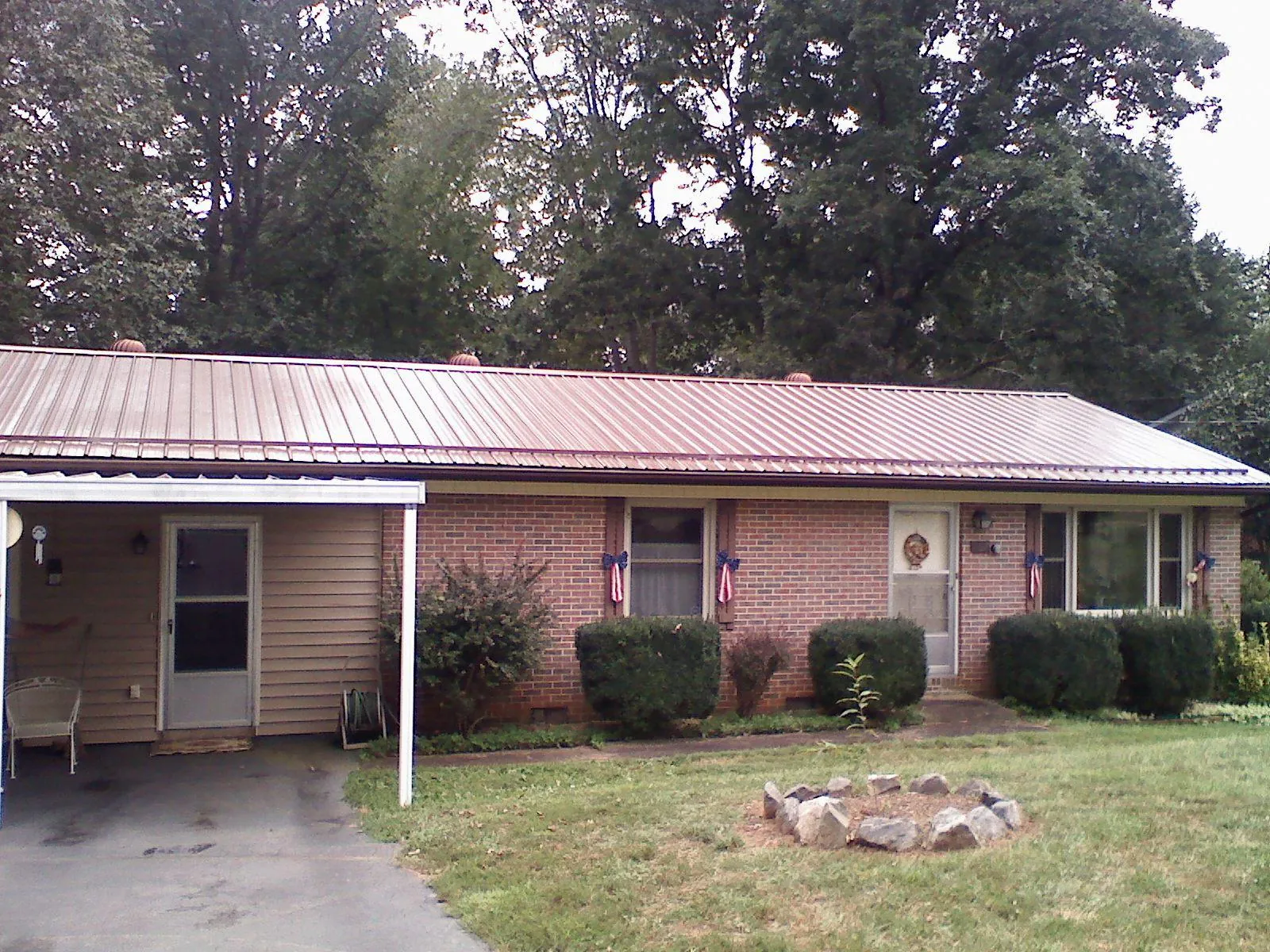 Bronze metal roof and carport on a brick ranch home — Roof Repair work by our crew in Coeymans Hollow